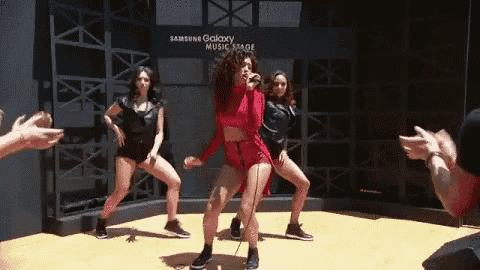 a group of women are dancing in front of a sign that says " samsung galaxy music stage "