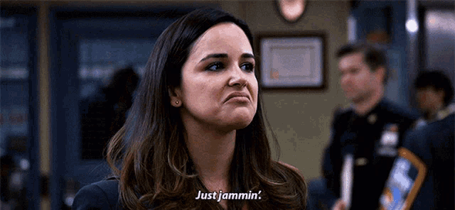 a woman is making a face and says just jammin .