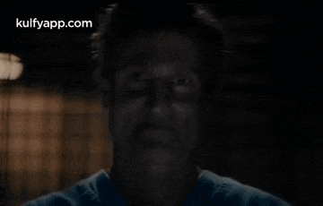 a close up of a man 's face with a blurred background and the words kulfyapp.com on the bottom .