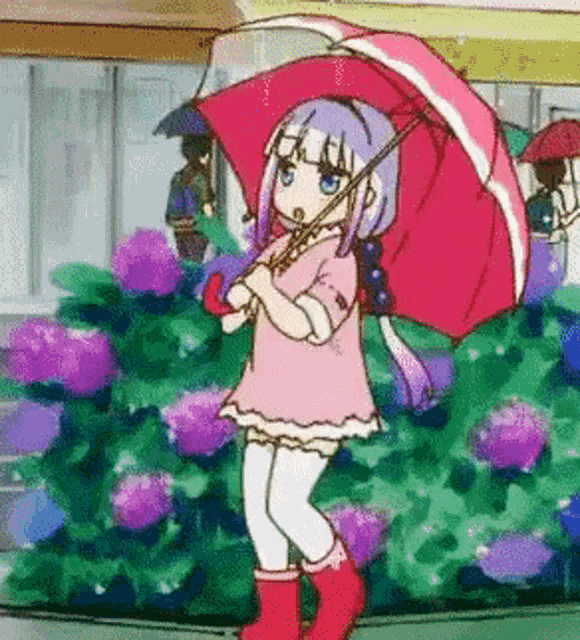 a girl in a pink dress is holding a red umbrella in the rain .