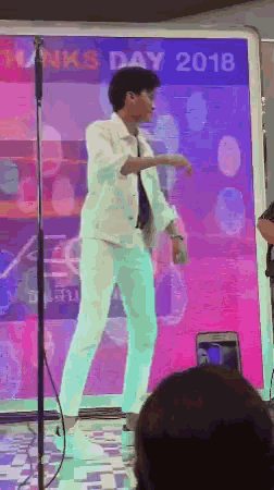 a man is dancing in front of a sign that says ' runks day 2018 '