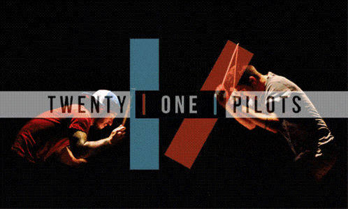 twenty one pilots performing on stage with a crowd behind them