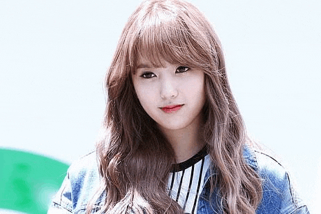 the girl is wearing a denim jacket and a striped shirt .