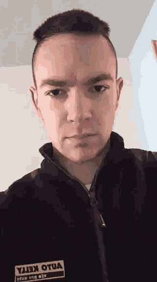 a man wearing a black jacket with the word volvo on it