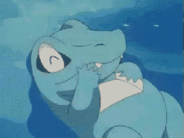 a blue crocodile is laying in the water with its mouth open