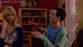 a man in a blue shirt is talking to a woman in a room with the words handsclean visible