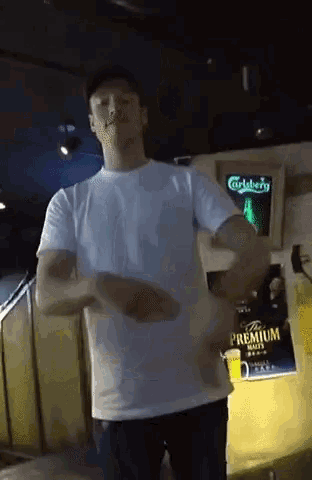a man is dancing in front of a carlsberg advertisement