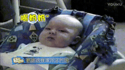 a baby is laying in a high chair with chinese writing on the bottom right