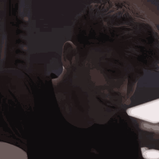 a close up of a young man 's face with a smile on his face