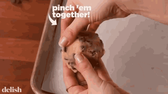 a person is holding a cookie in their hands with the words pinch 'em together written above them