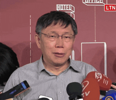 a man stands in front of a red wall with the word hotel written on it