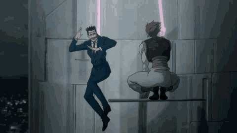 a man in a suit is jumping in the air while another man is squatting on a bar