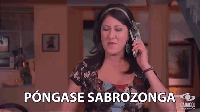 a woman is talking on a cell phone with the words pongase sabrozonga written below her