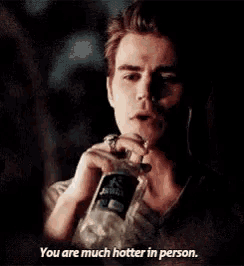 a man is drinking water from a bottle and says `` you are much hotter in person . ''