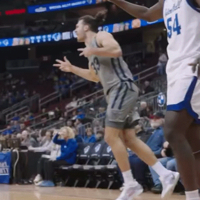 a basketball player with the number 54 on his jersey is jumping on the court .