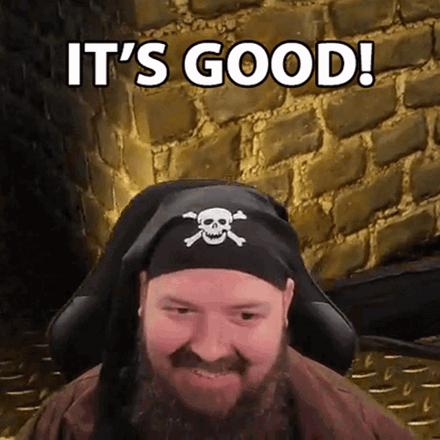 a man with a beard wearing a pirate hat with a skull and crossbones on it says it 's good