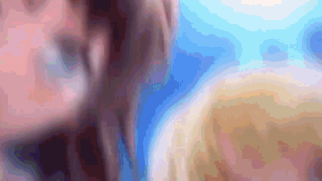 a blurry picture of a person 's face with a blue sky in the background