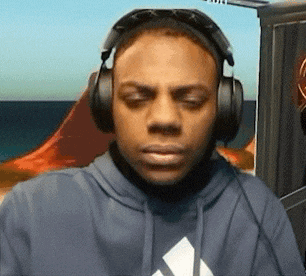 a man wearing headphones and sunglasses looks at the camera .
