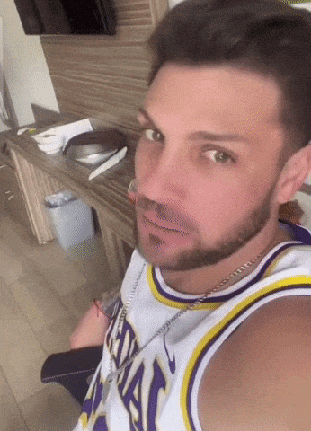 a man with a beard and a lakers jersey