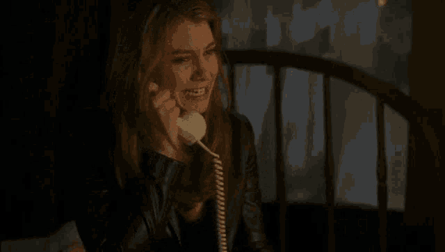 a woman is crying while talking on a phone .
