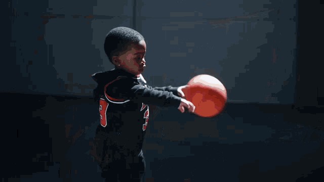 a man in a bulls jersey stands next to a baby