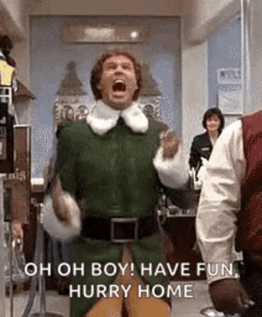 a man in a green elf costume is standing in a room with his mouth open and screaming .