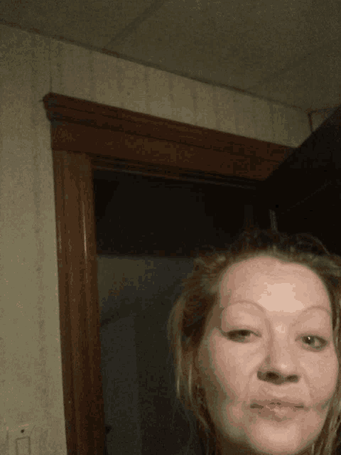 a woman taking a selfie with a door in the background