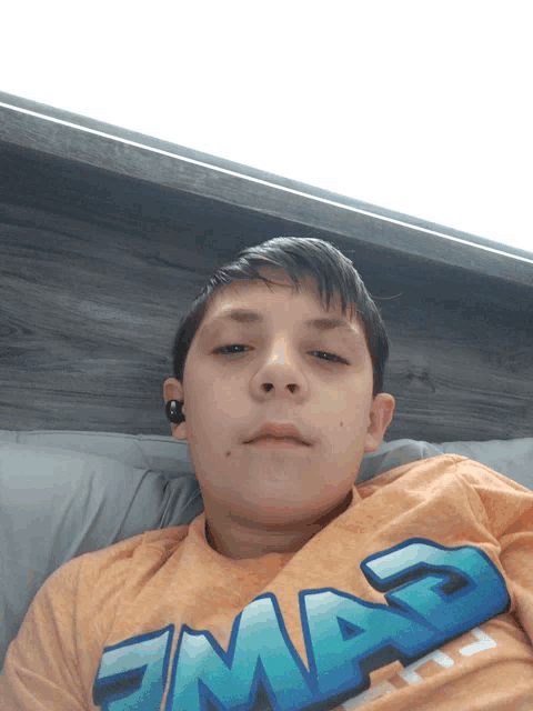 a boy wearing a shirt that says mad on it