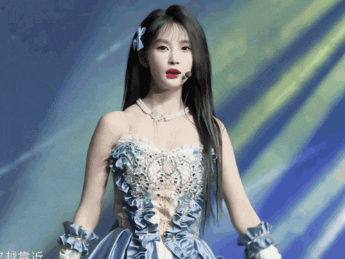 a woman in a blue and white dress with chinese writing on the bottom