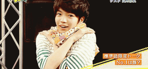 a person with a scarf around their neck and a sign that says no.1 on it