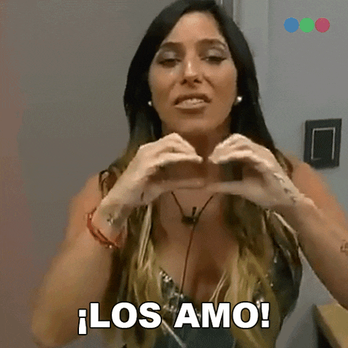 a woman making a heart shape with her hands and the words los amo behind her