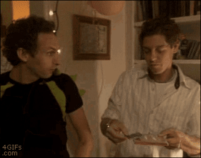 two men are standing next to each other with a 4gifs.com watermark on the bottom of the image