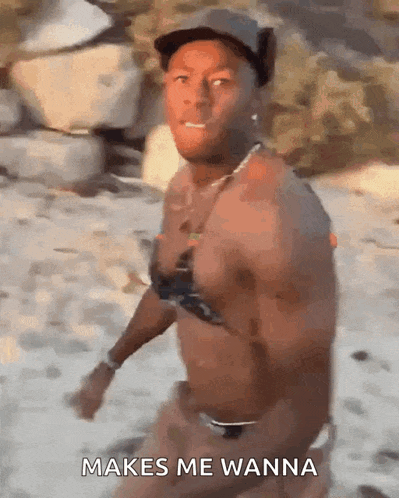 a shirtless man in a bikini is walking on a beach and says " makes me wanna "