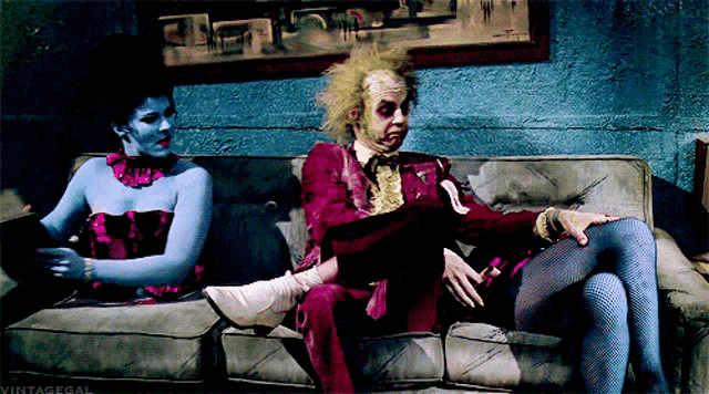 a man and a woman are sitting on a couch with vintagegal written on the bottom