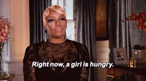 a woman in a black lace top is saying right now a girl is hungry