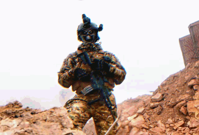 a soldier with a helmet on holds a gun