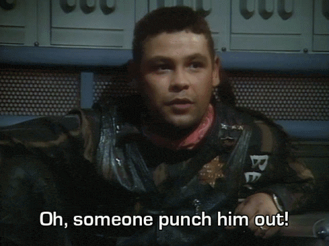 a blurry picture of a man with the words oh someone punch him out