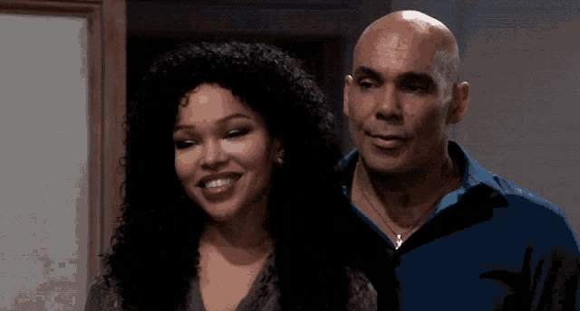 a man and a woman are posing for a picture and smiling