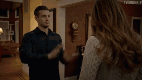 a man and a woman are standing in a hallway with the hashtag youngertv