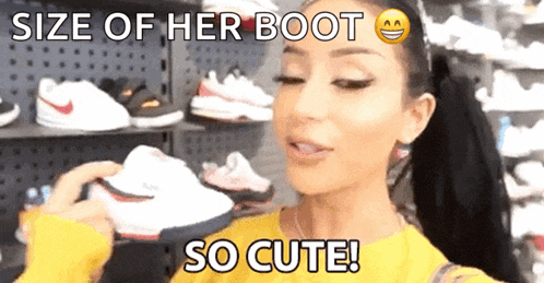 a woman in a yellow sweater is holding a pair of shoes with the caption size of her boot so cute ..