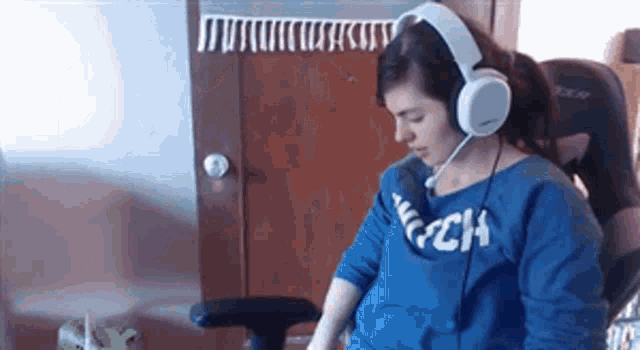 a woman wearing headphones and a blue shirt with the word abercrombie on it
