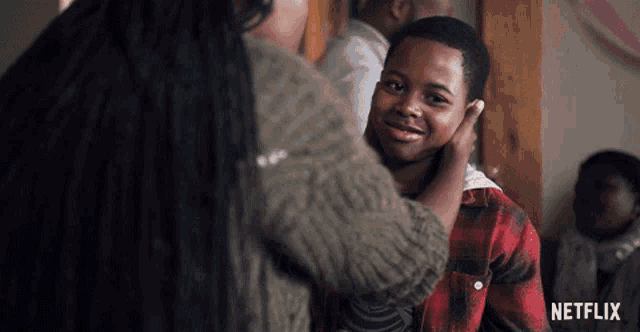 a netflix ad shows a woman touching a young boy 's head