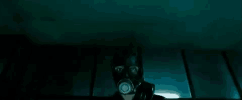 a close up of a person wearing a gas mask in the dark .