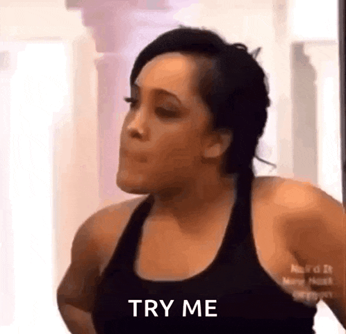 a woman is making a funny face and says `` try me '' .