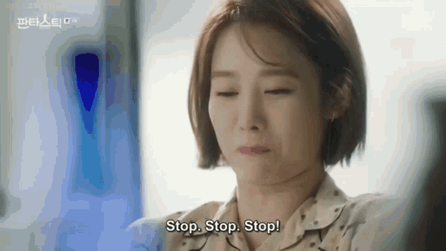 a woman is sitting in a chair with her eyes closed and says stop stop stop !
