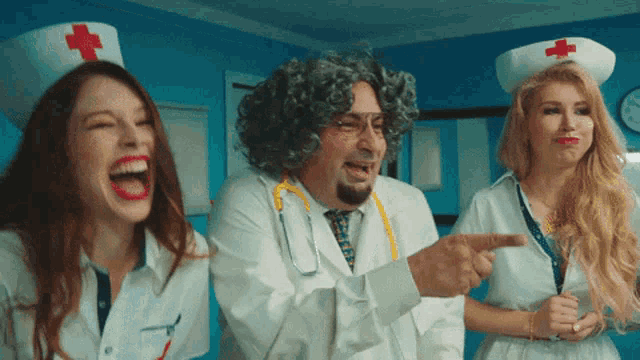 two nurses and a doctor with a red cross on their hats are laughing