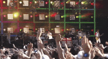 a crowd of people watching a band perform on stage