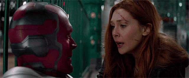 vision and scarlet witch are looking at each other in a movie scene .
