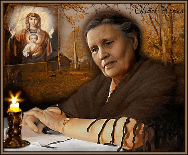 a woman sitting at a table with a candle and a painting of a woman holding a baby