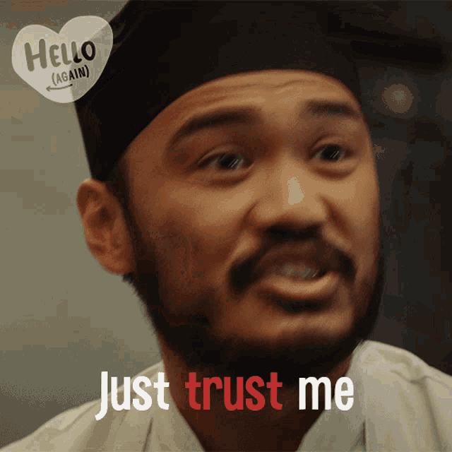 a man with a beard says " just trust me " in front of a hello again sticker